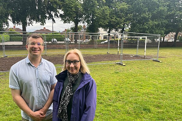 Will Frass and Jane Brophy stood with the fencing over the freshly seeded grass